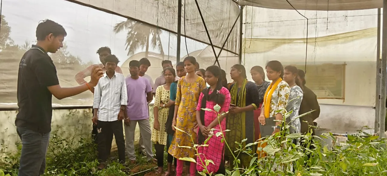 IGO Academy faculty demonstrating farm techniques to students